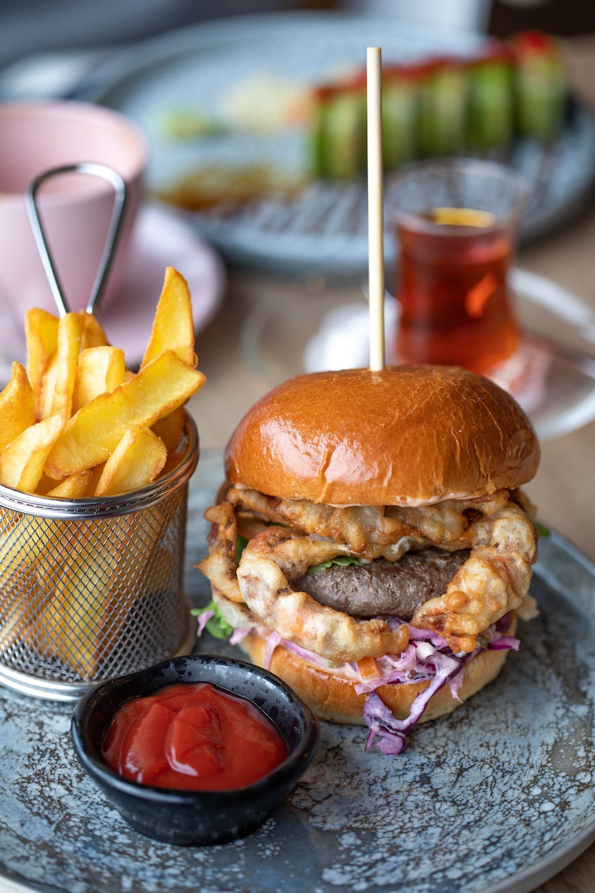 big hamburger served with chips and ketchup
