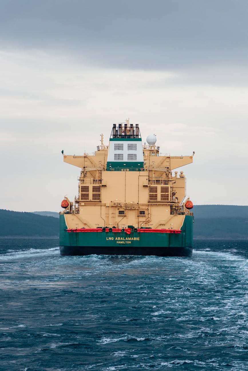 a yellow and green sea vessel under a blue sky