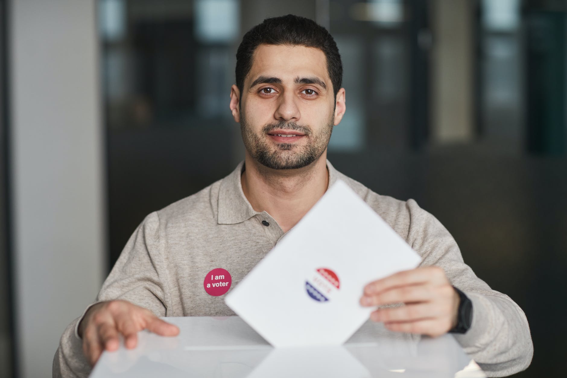 man standing by the ballot box