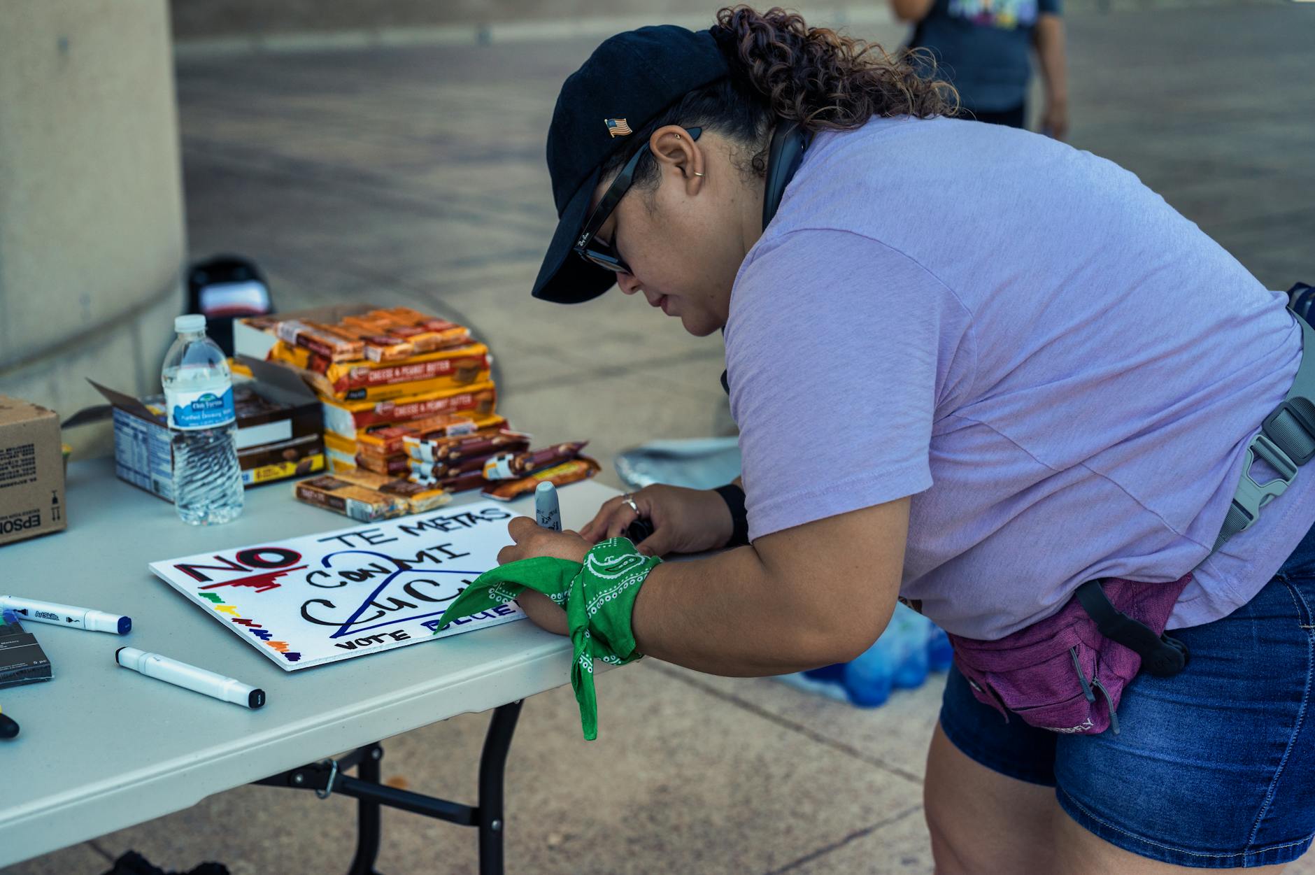 demonstrator writing slogans on a banner