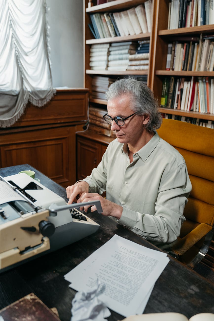 man in gray dress shirt wearing black framed eyeglasses