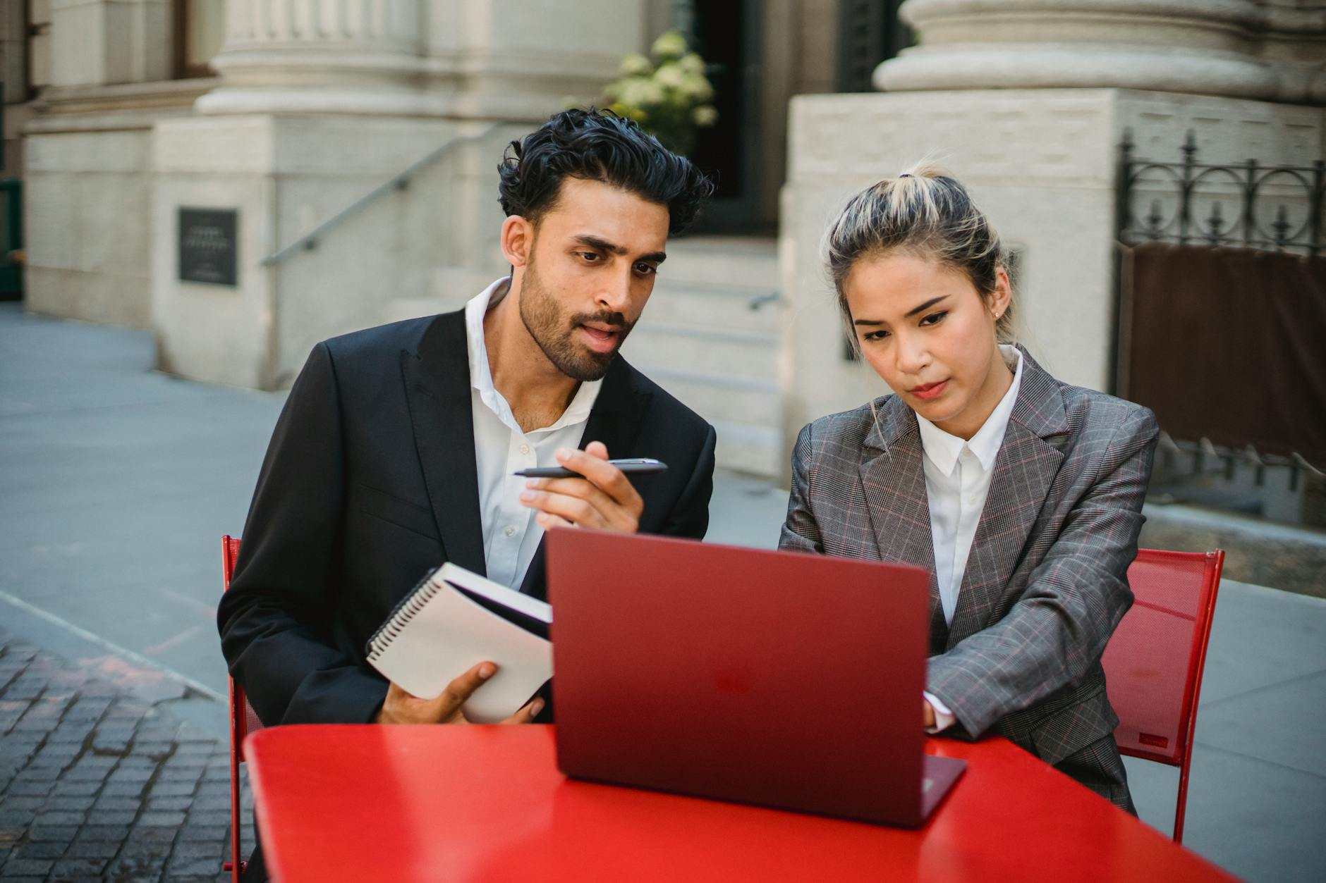 man and woman in front of a laptop