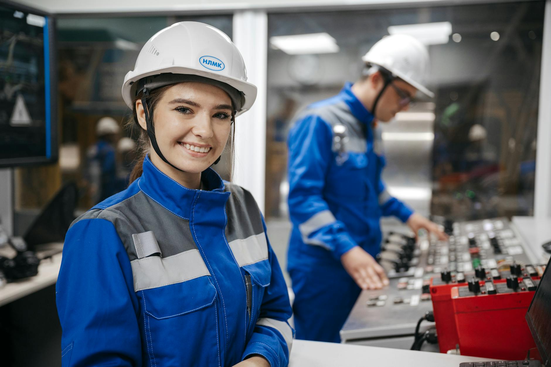 industrial workers in control room smiling woman