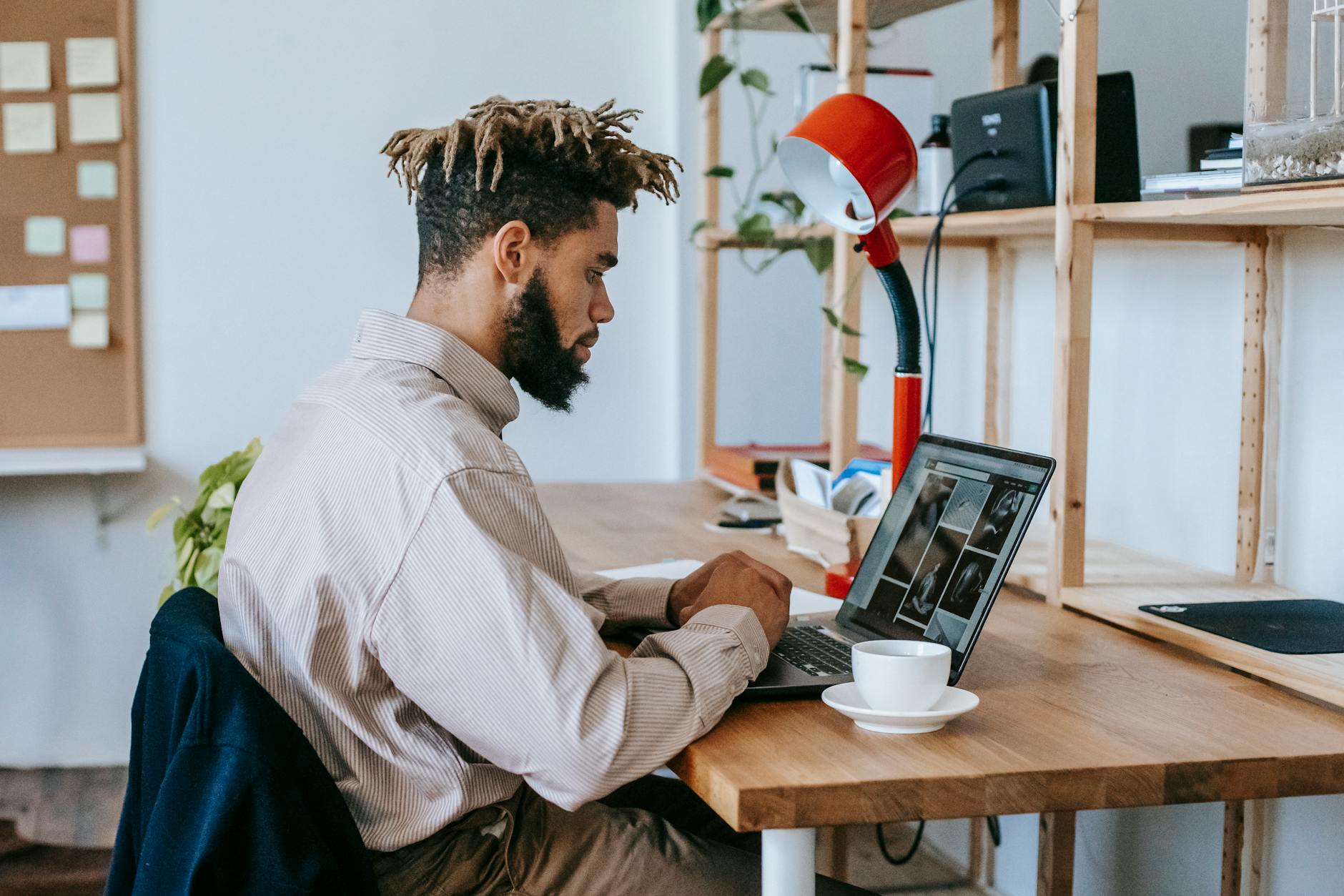black man remote worker using computer in workplace