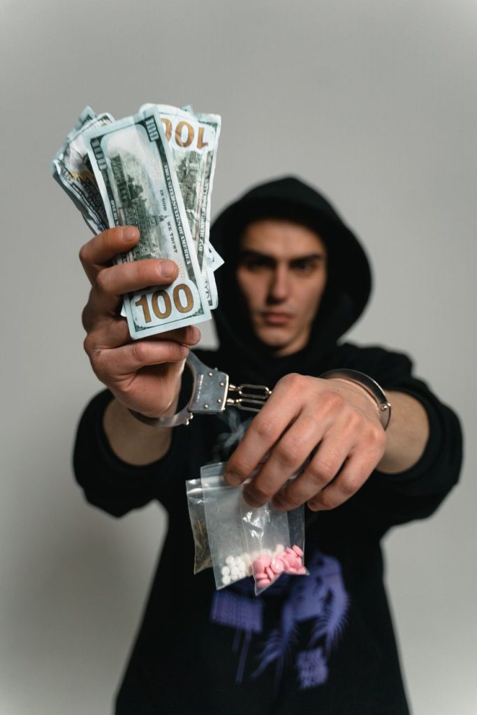 Current image: a man in handcuffs arrested for illegal drugs trade