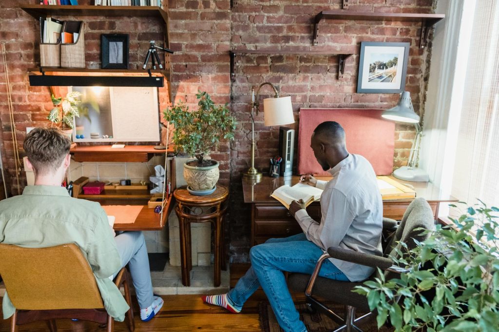 Current image: two men reading books in a room