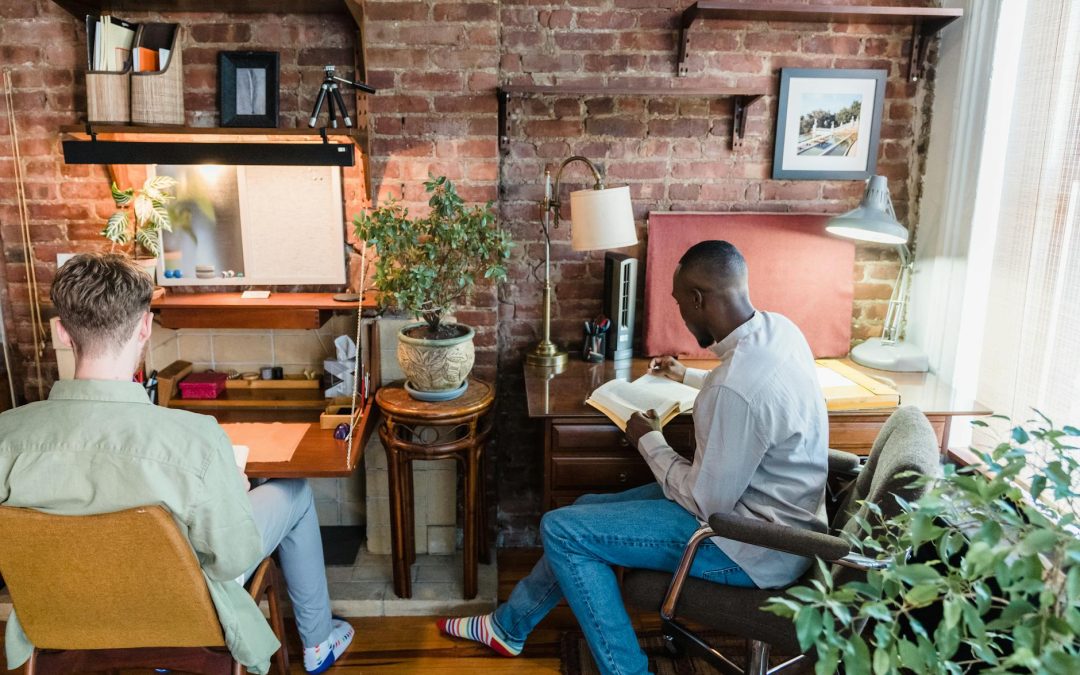 two men reading books in a room
