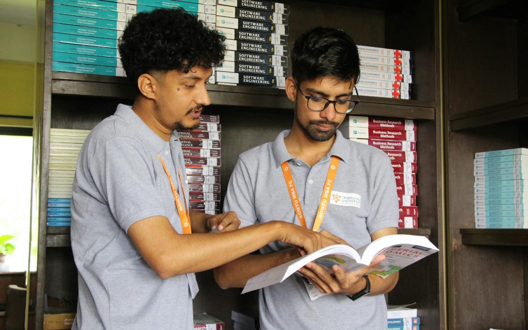 college students discussing study material in library