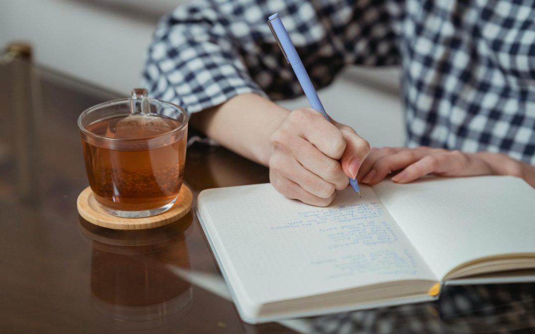 woman writing notes in a notebook