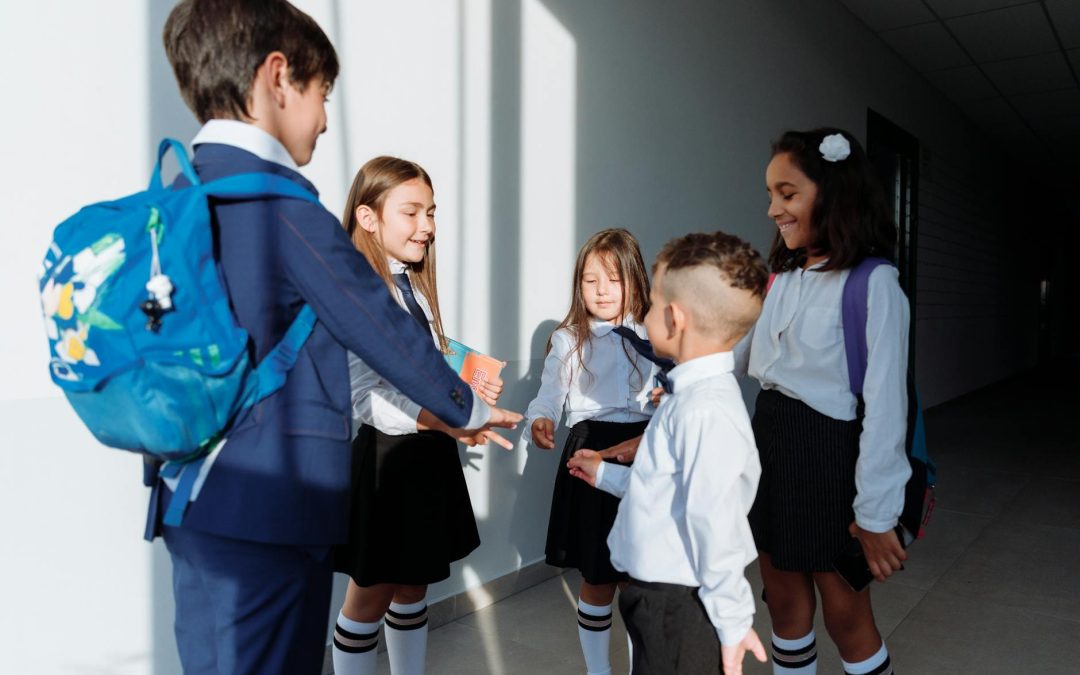 children in school uniform playing rock paper scissors