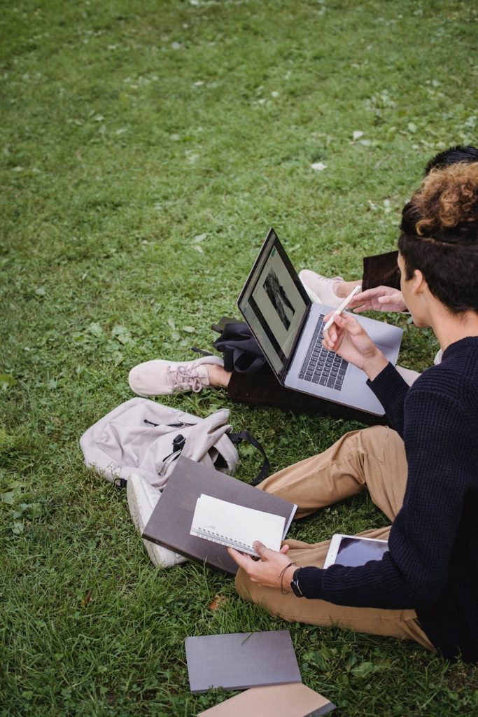 Current image: students studying on green grass field