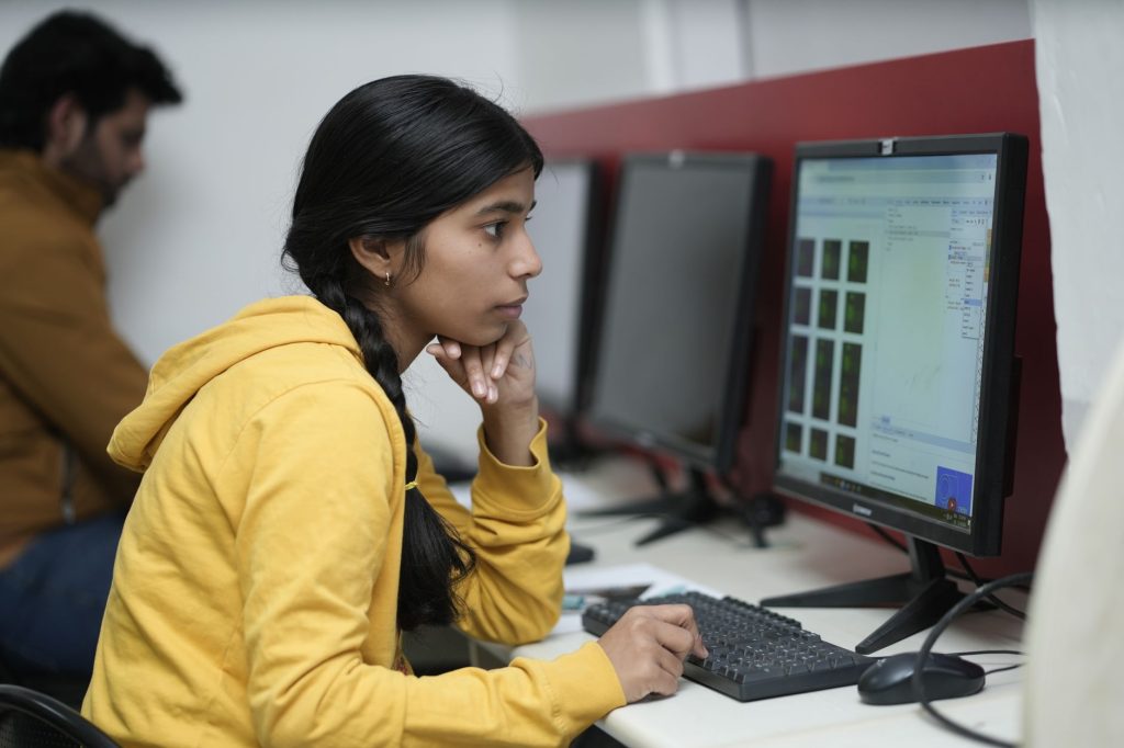 Current image: young woman working at computer in office setting