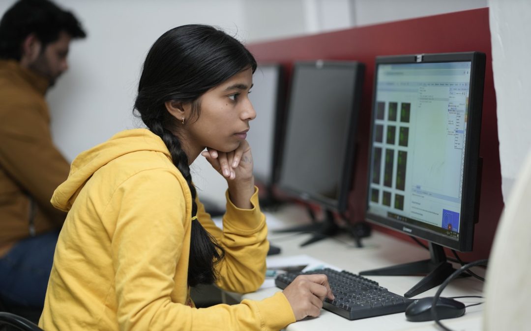 young woman working at computer in office setting