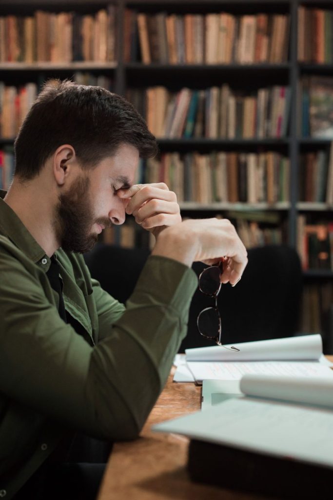 Current image: man holding his eyeglasses