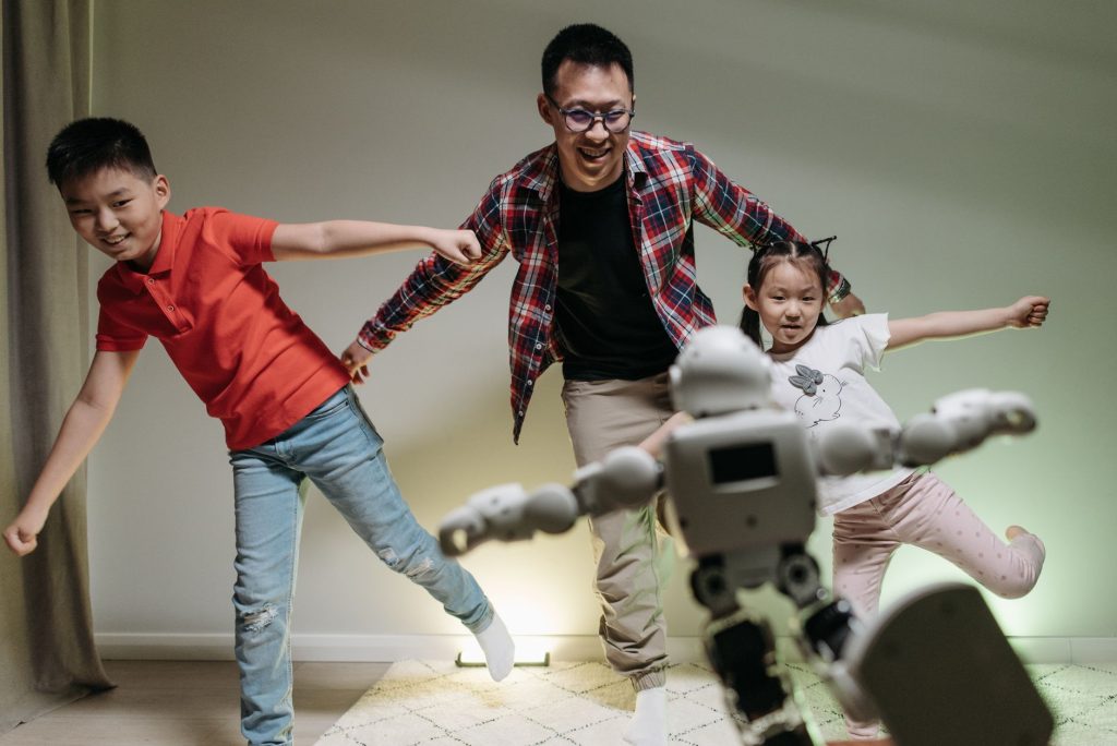 Current image: a happy family dancing with the robot