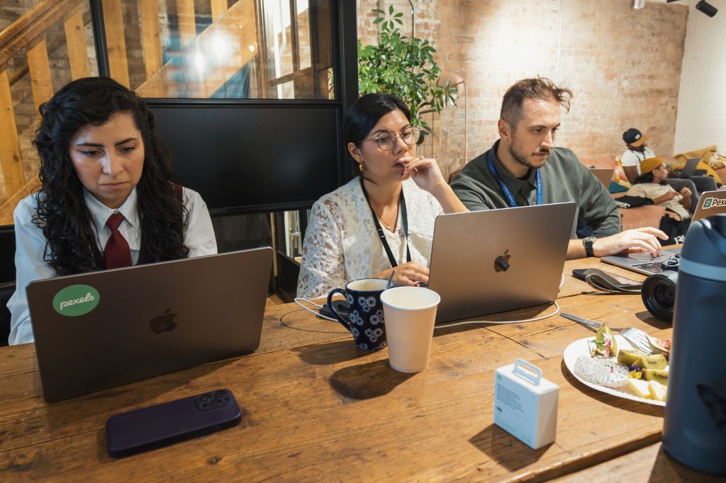 Current image: team focused on coursework in modern workspace