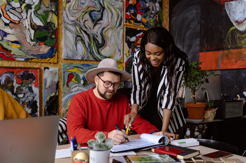 Current image: man and woman working together in creative office