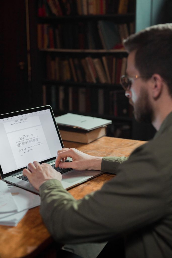 Current image: man typing on laptop