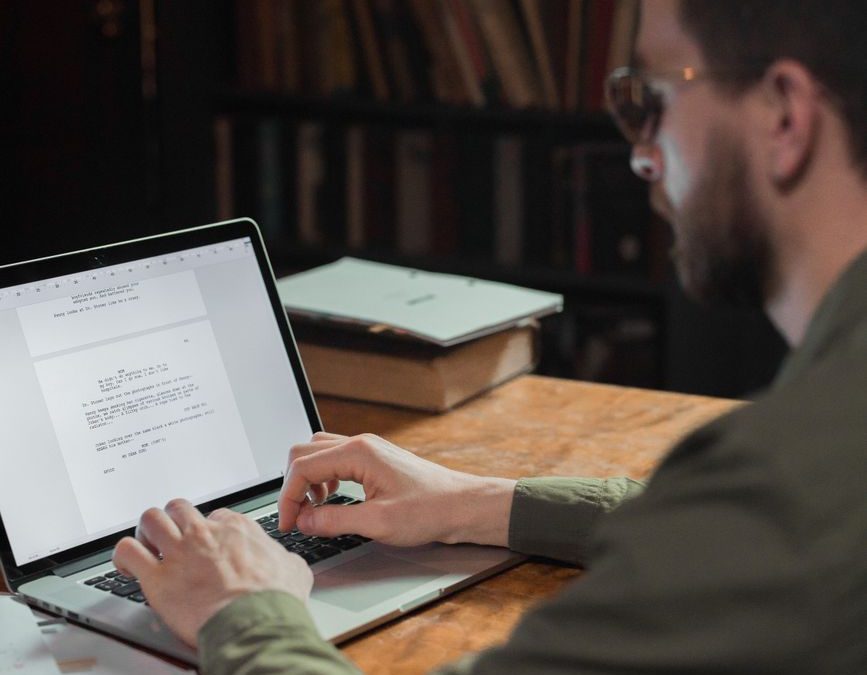 man typing on laptop
