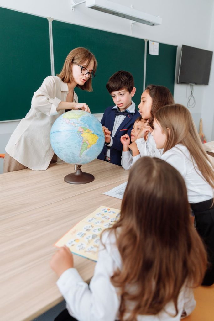 Current image: teacher discussing her lesson about geography
