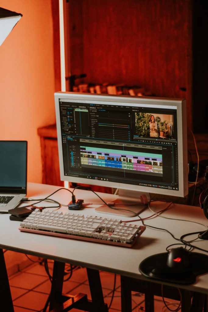 Current image: computer monitor beside a laptop