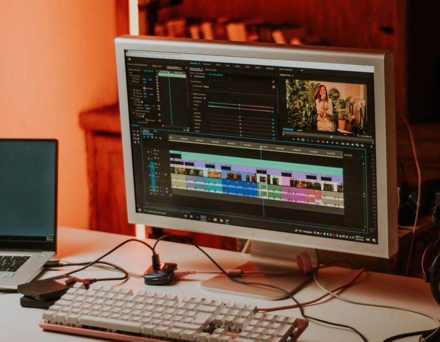 computer monitor beside a laptop