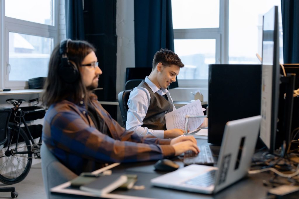 Current image: men sitting at the desk
